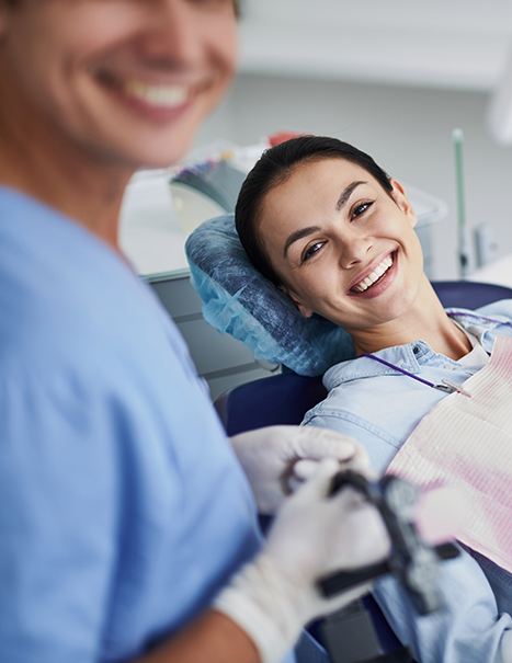 Dentist in Mission Viejo evaluating a patient's smile for dental bonding 