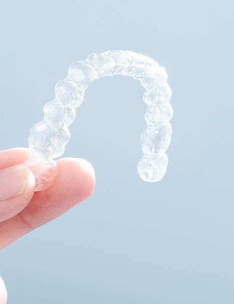 Patient holding clear aligner